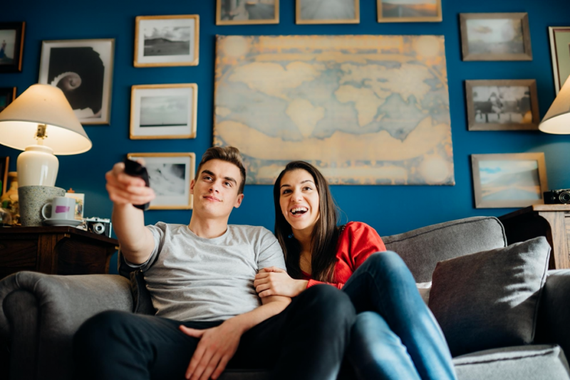 a couple streaming tv on the couch together