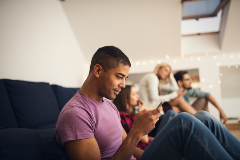 man looking at sms text message on phone