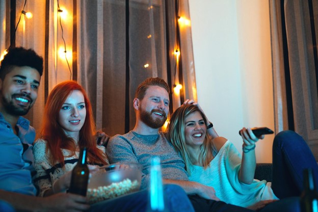 Four Friends Watching TV Together with Popcorn